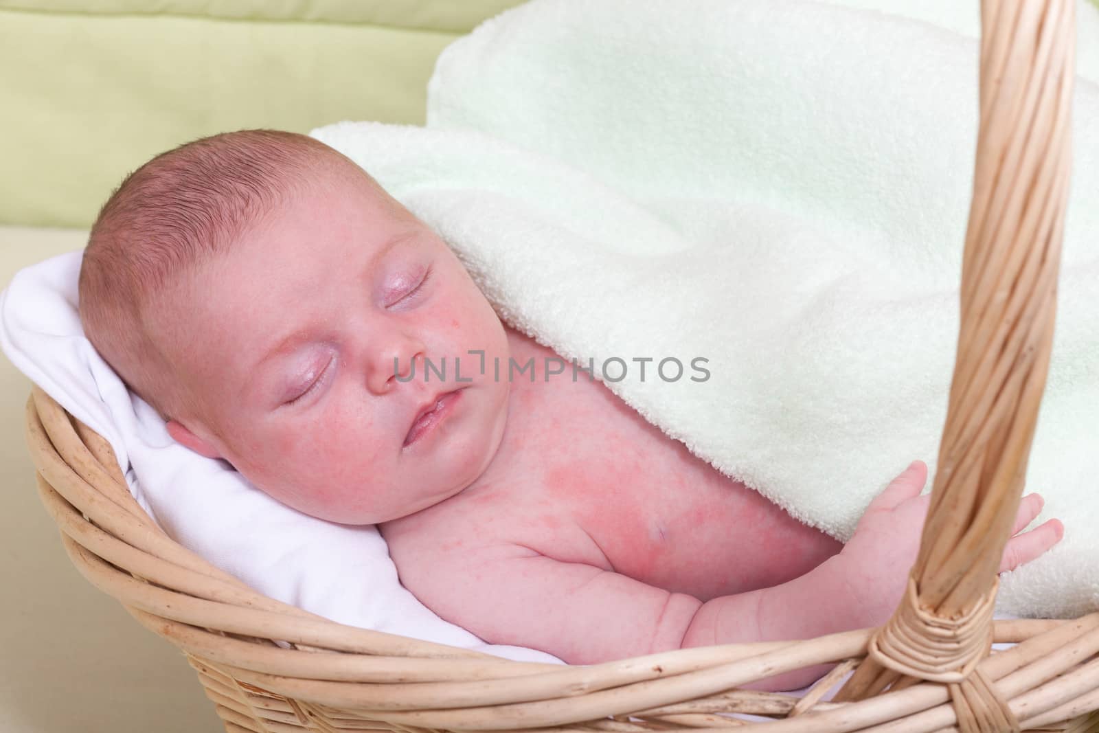 Baby sleeps in a wattled basket, a close up