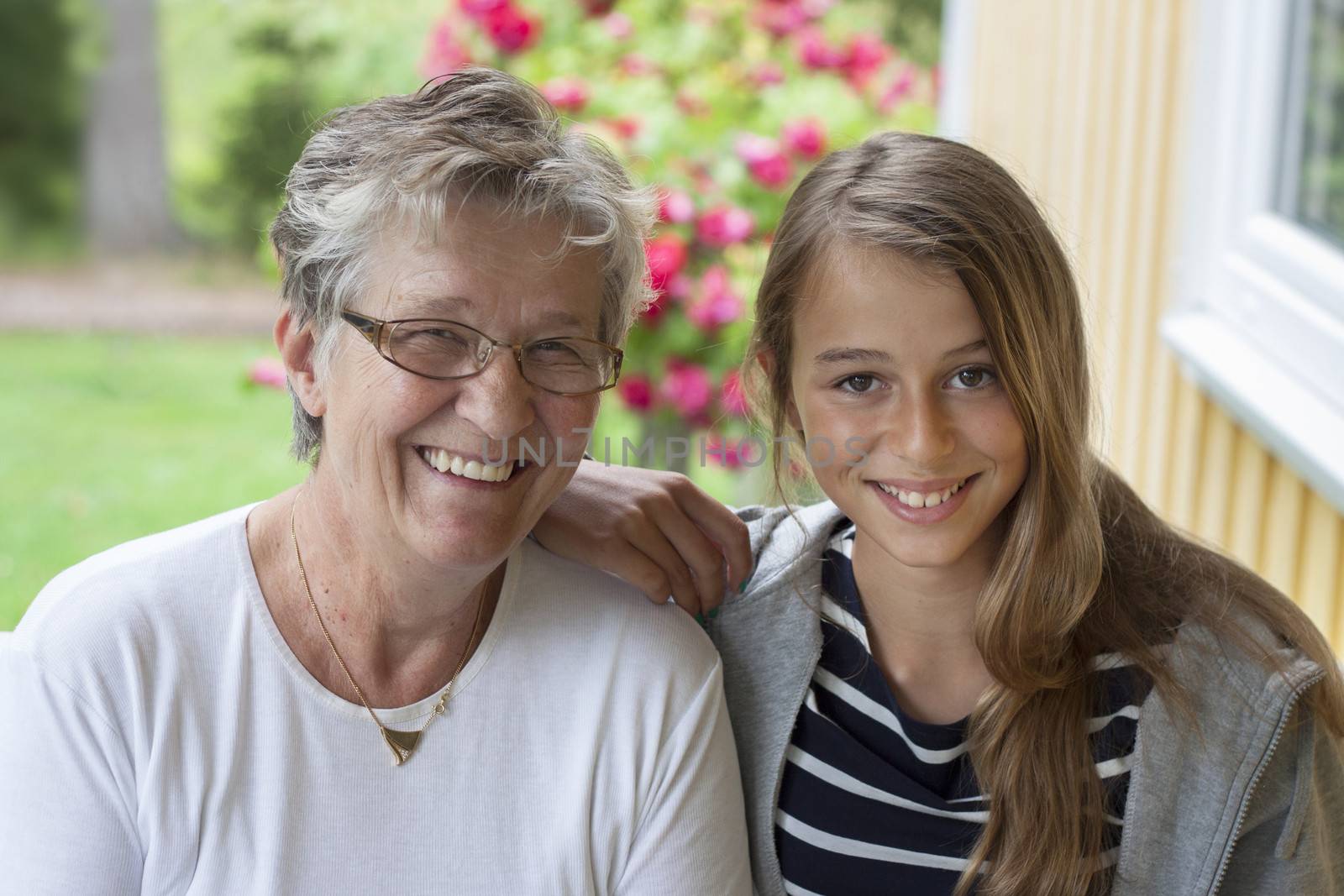 Grandmother and grandchild looking at camera