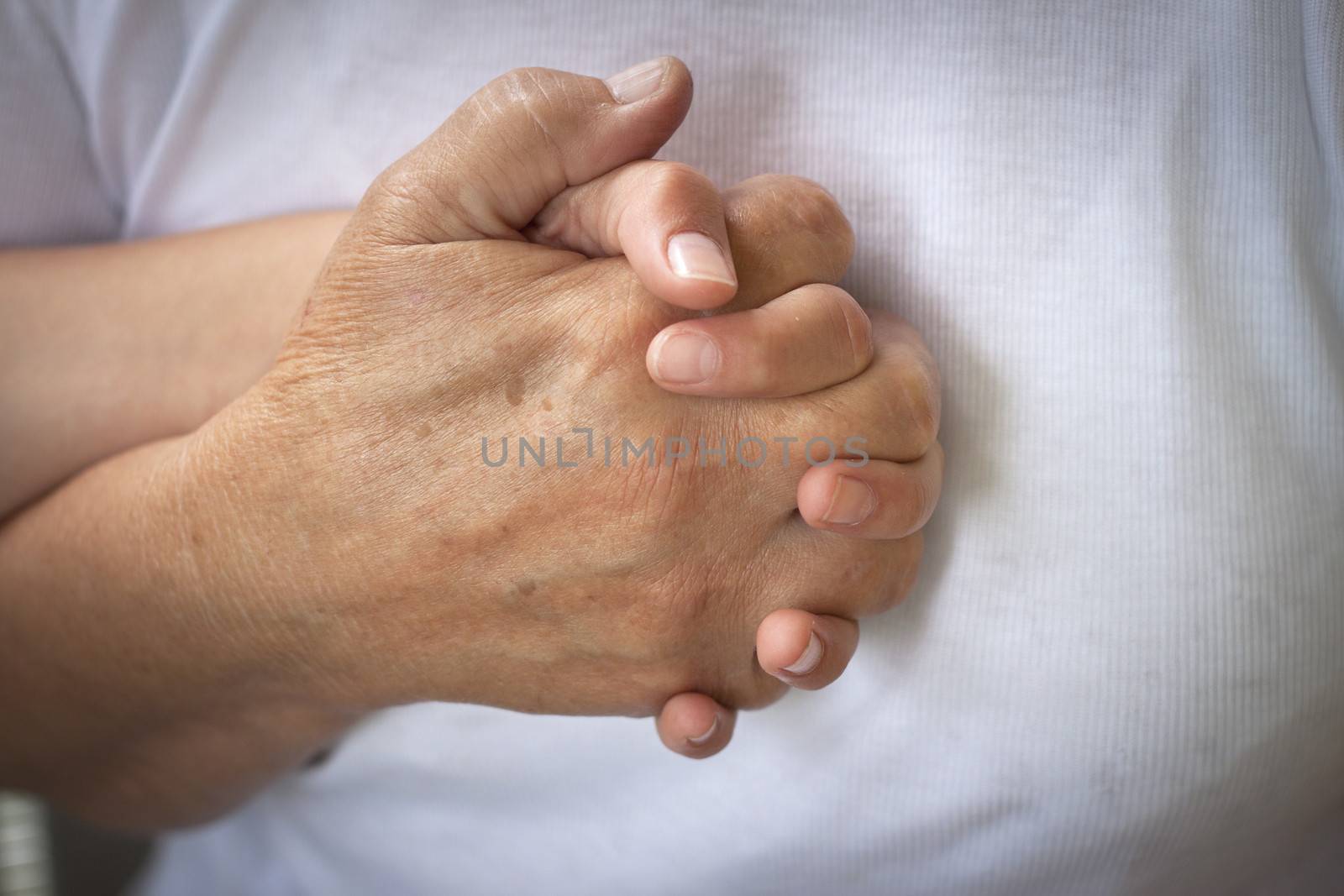 an old woman holding a young girls hand