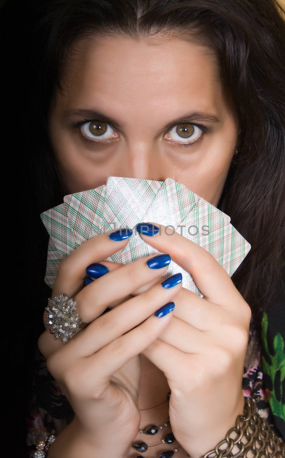 Gypsy woman with fan of cards and mysterious look