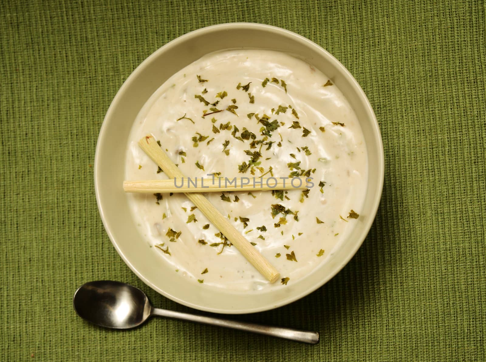 creamy lemongrass soup with garnish and spoon