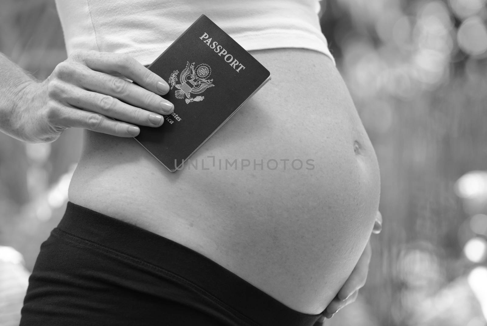 international travel during pregnancy concept with pregnant woman holding passport