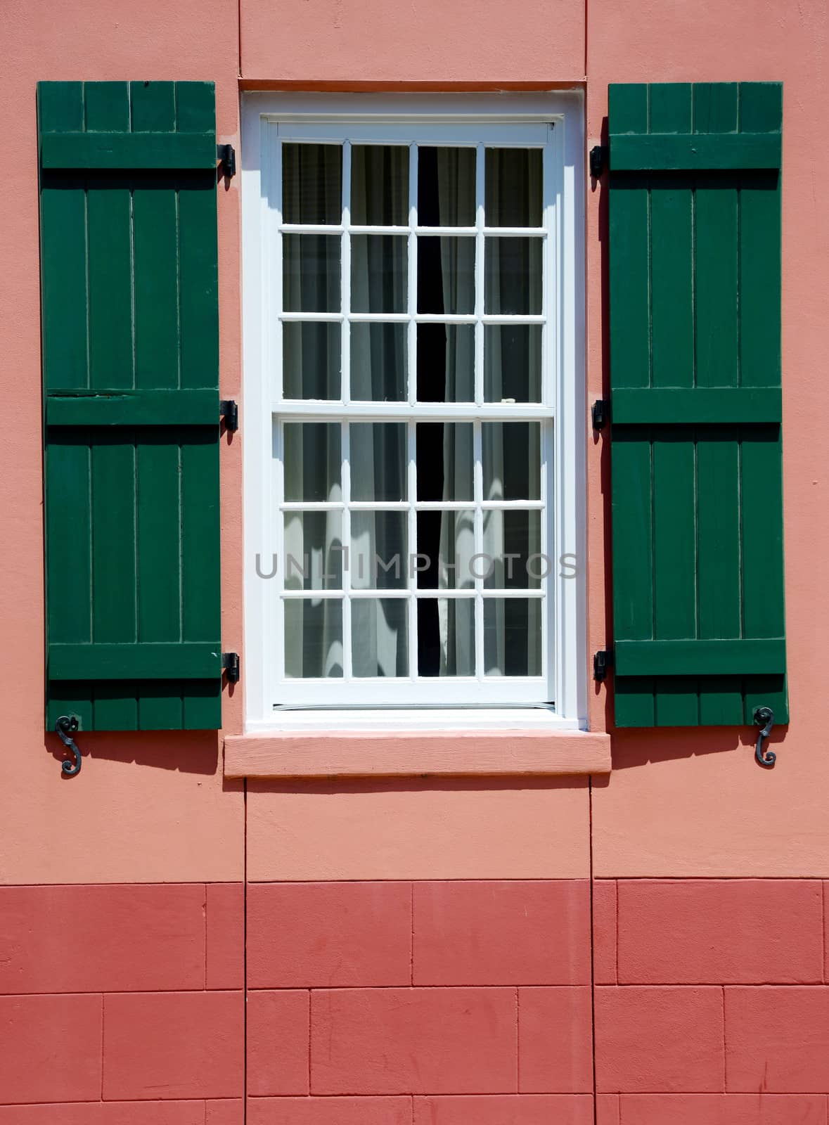 window with green shutters in european village