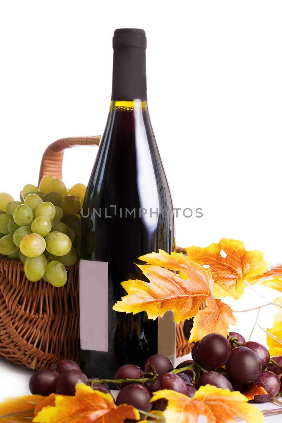Bottle of wine with grapes in basket by Angel_a