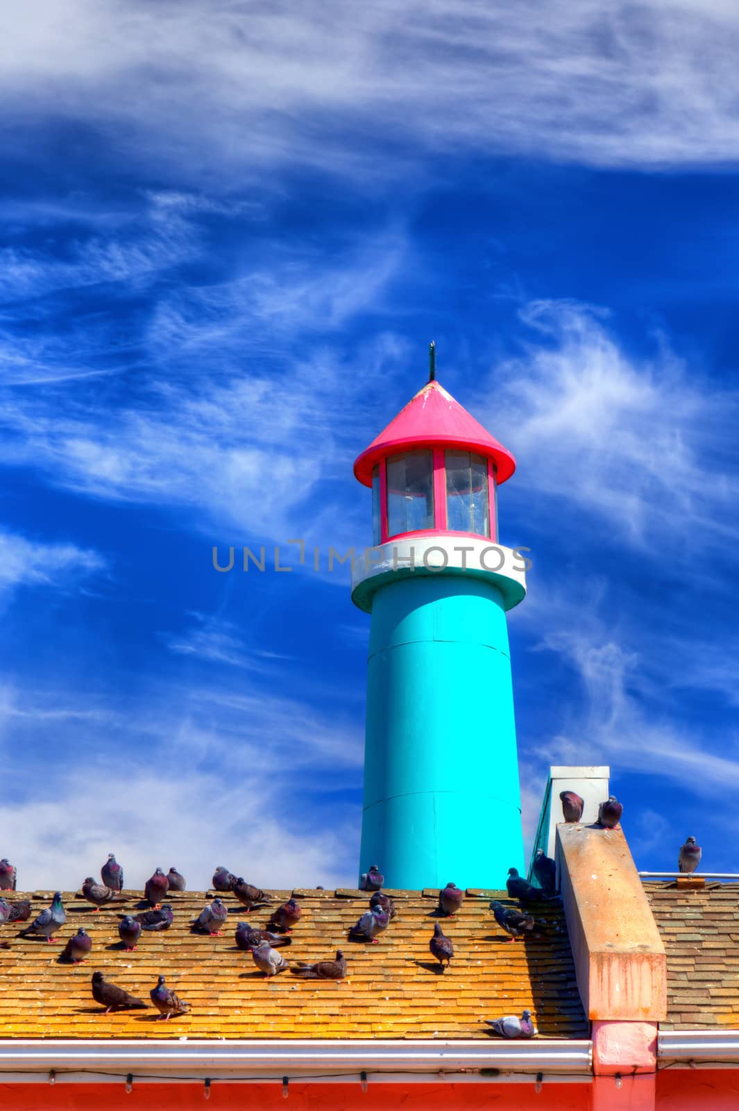 A Lighthouse with Backdrop of Blue Sky and Clouds