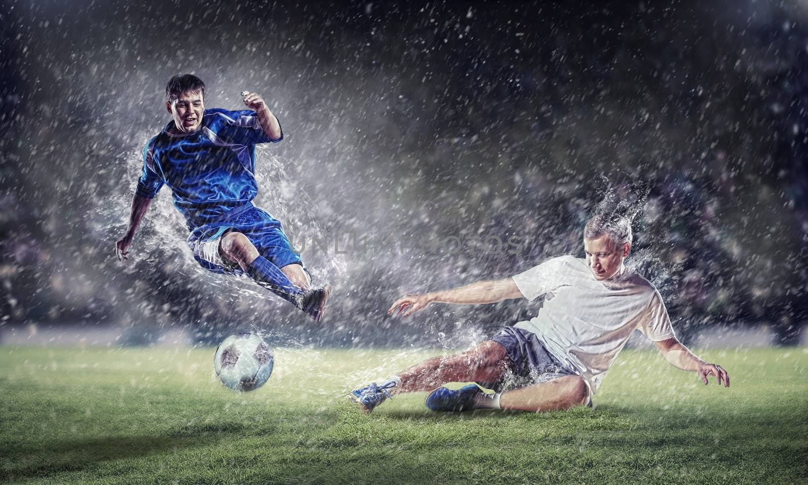 two football players in jump to strike the ball at the stadium