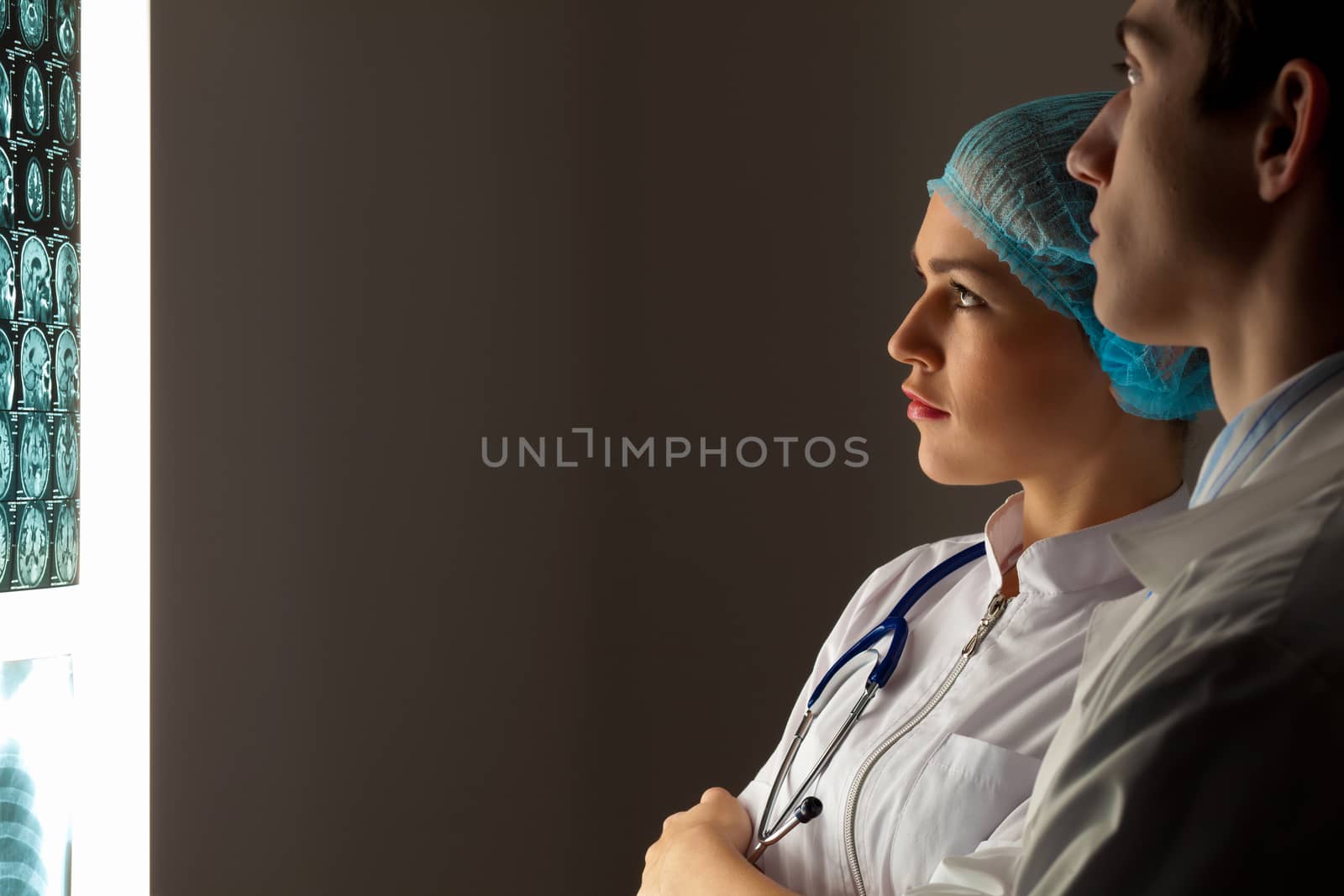 Two doctors examining x-ray results by sergey_nivens