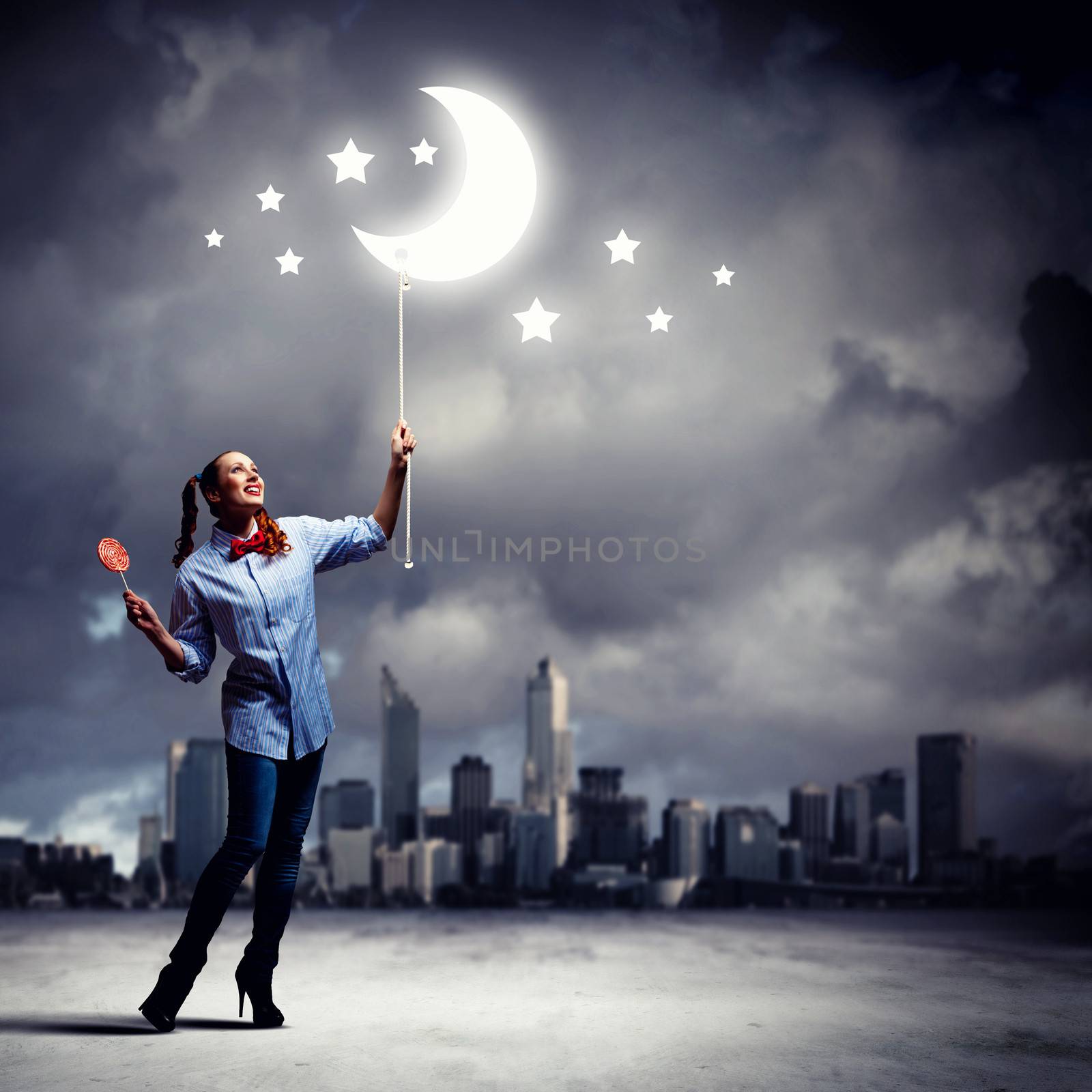 Funny teenager girl with candy against city background
