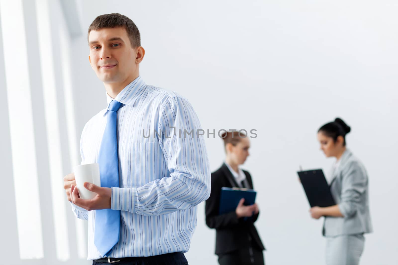 Image of three young businesspeople laughing joyfully