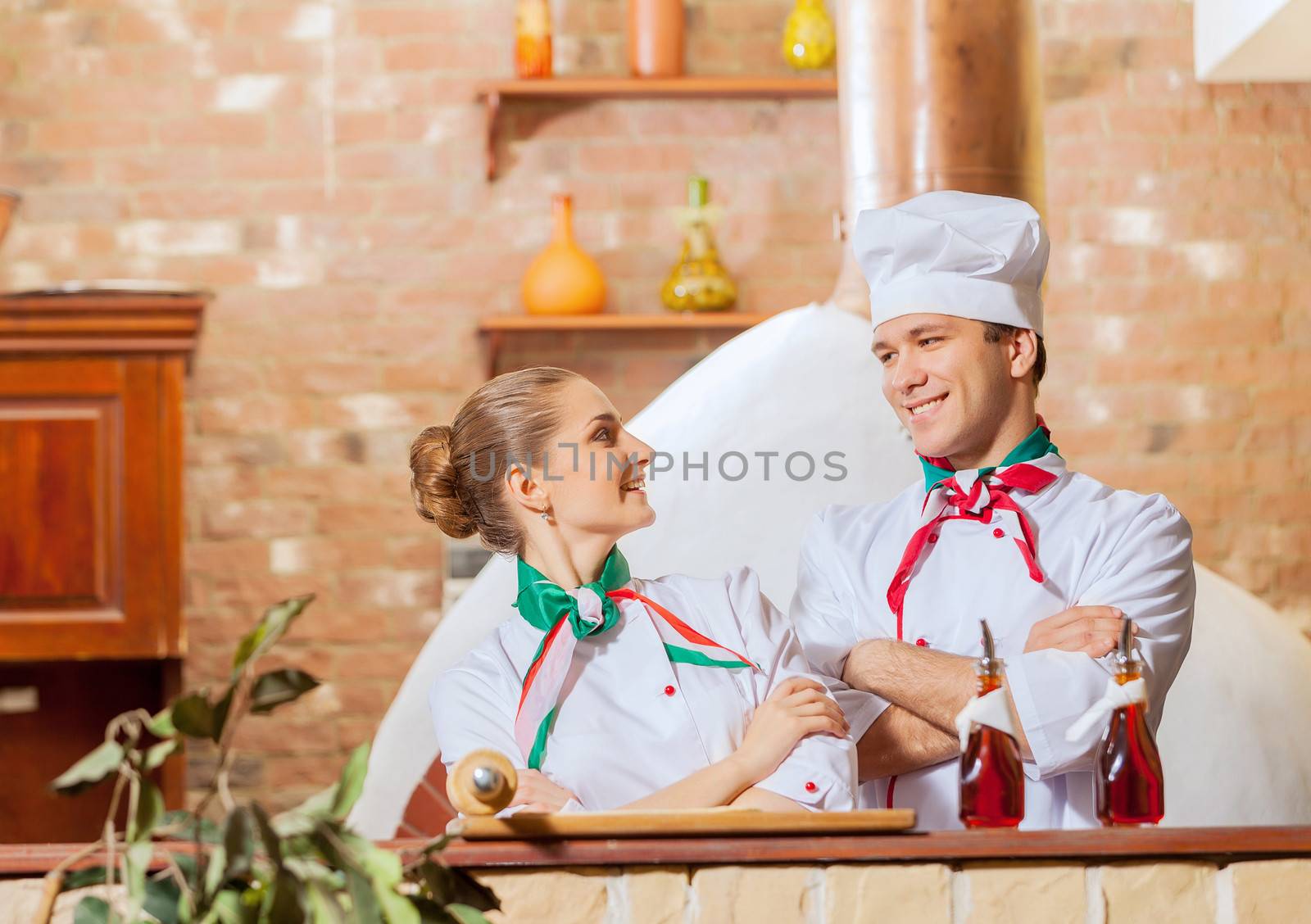 Portrait of two cooks with crossed arms looking at the camera