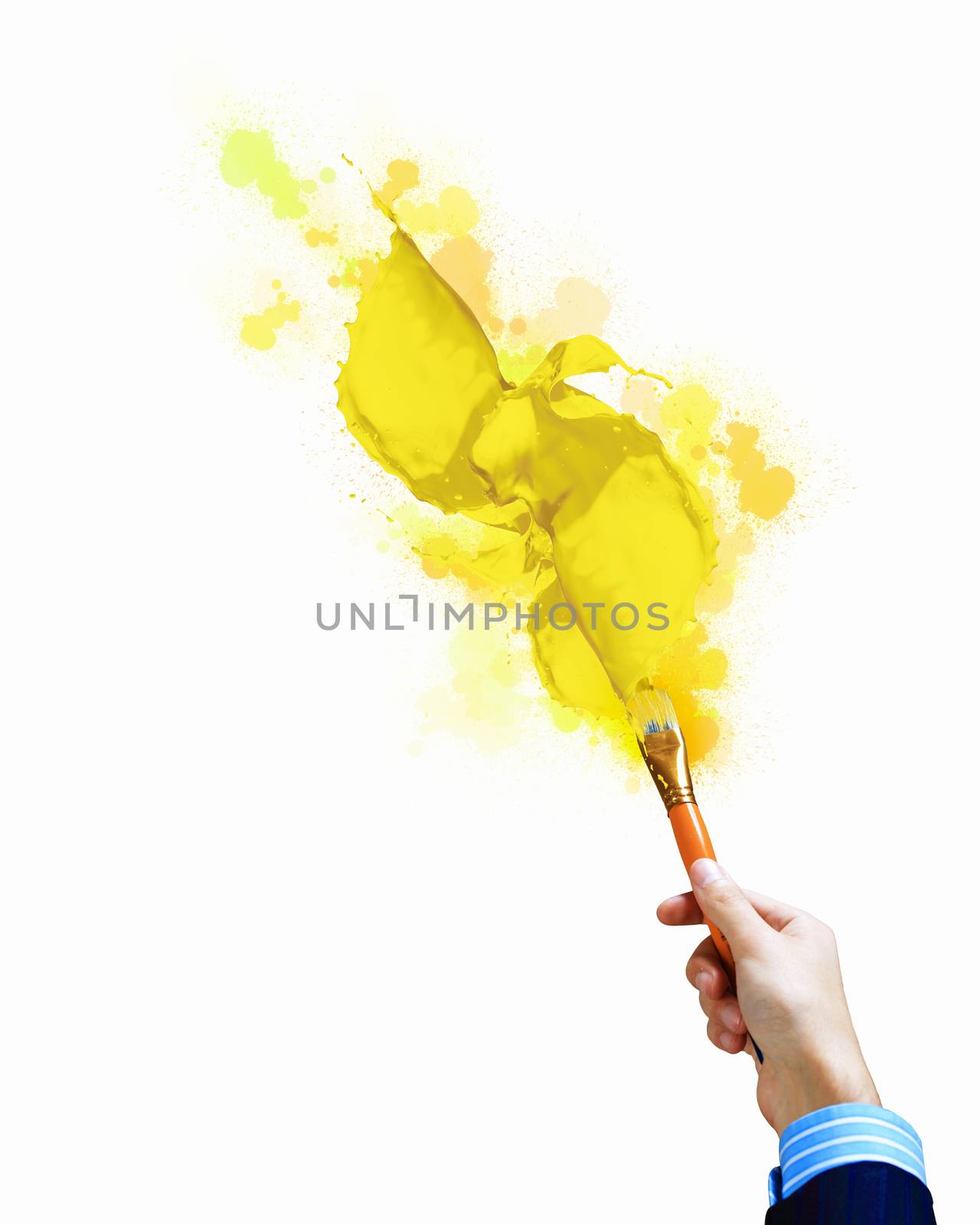 Close-up of human hand holding paint brush making colorful paint splashes