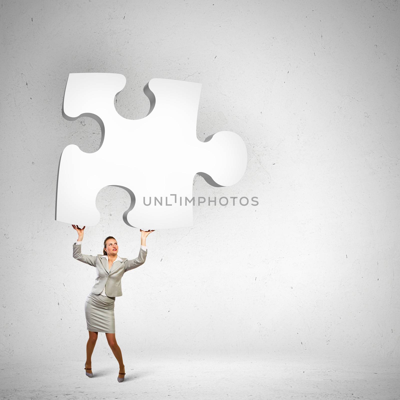 Businesswoman holding puzzle element by sergey_nivens