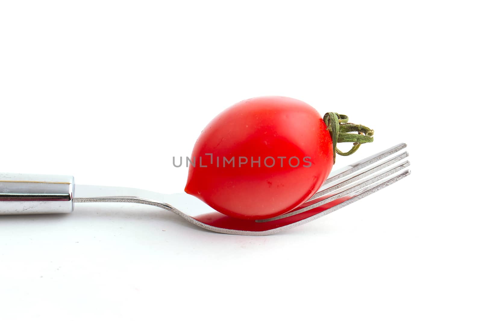 cherry tomato on fork isolated on white