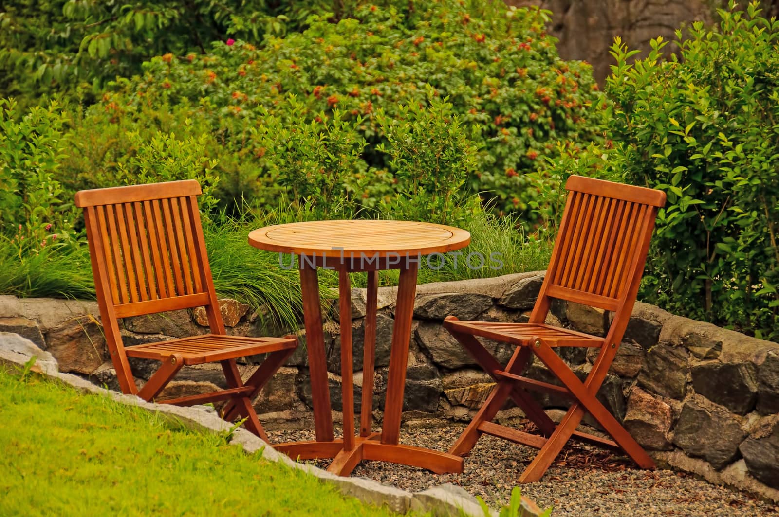 Classic hardwood garden furniture in a summer garden