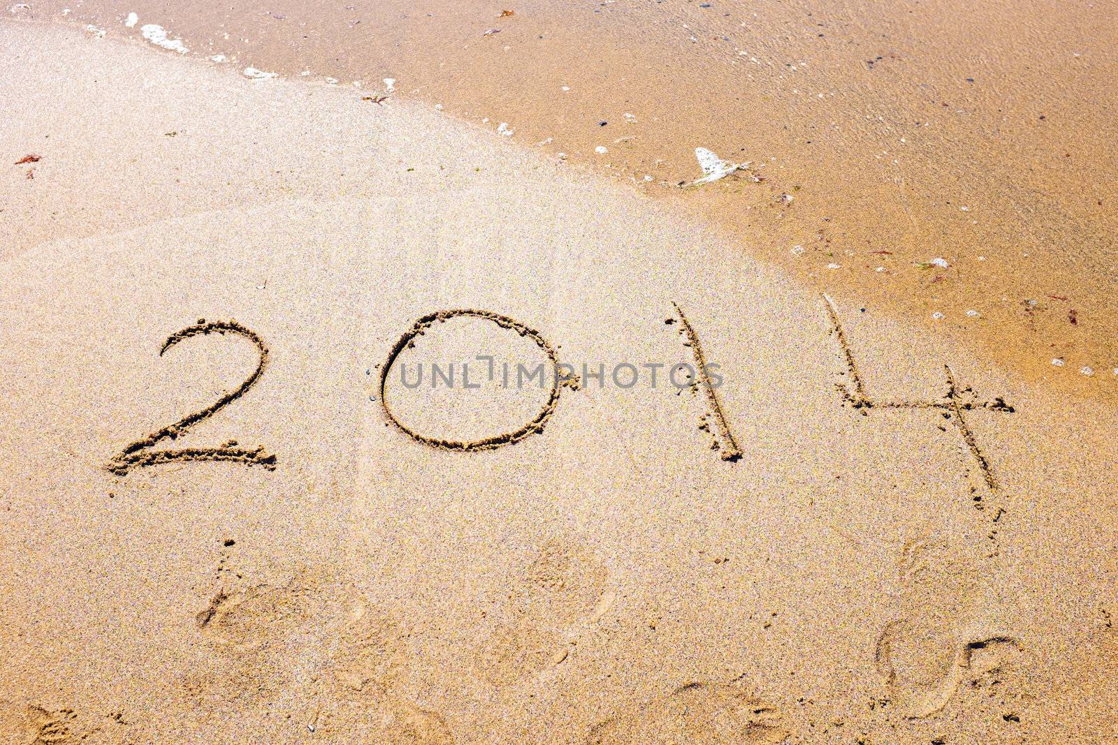 Happy New Year, 2014 written in sand at the beach