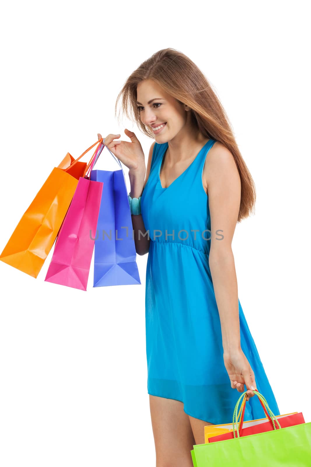 attractive young woman with colorful shopping bags isolated on white background