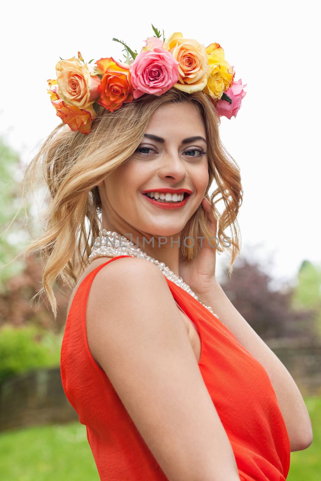 beautiful woman portrait outdoor with colorful flowers and red lips