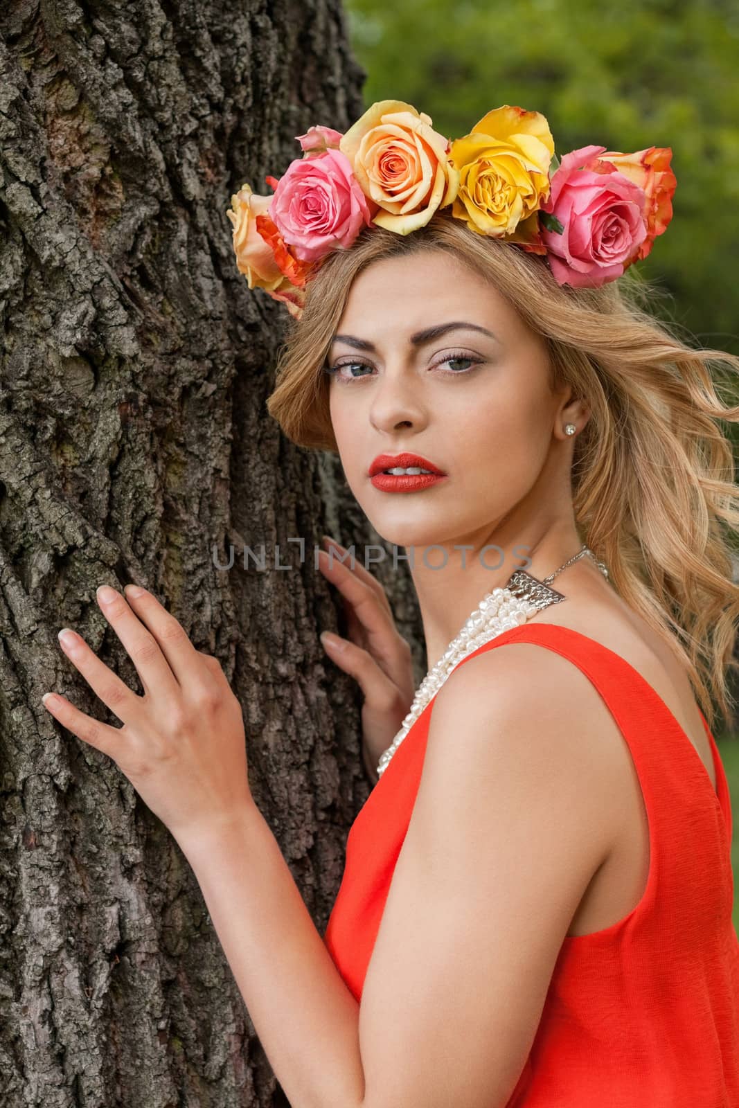 beautiful woman portrait outdoor with colorful flowers and red lips