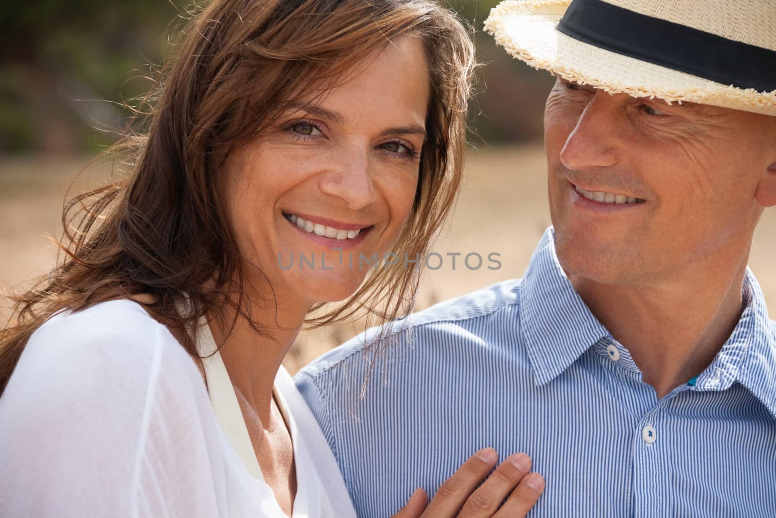 happy adult couple in summertime on beach having fun vacation