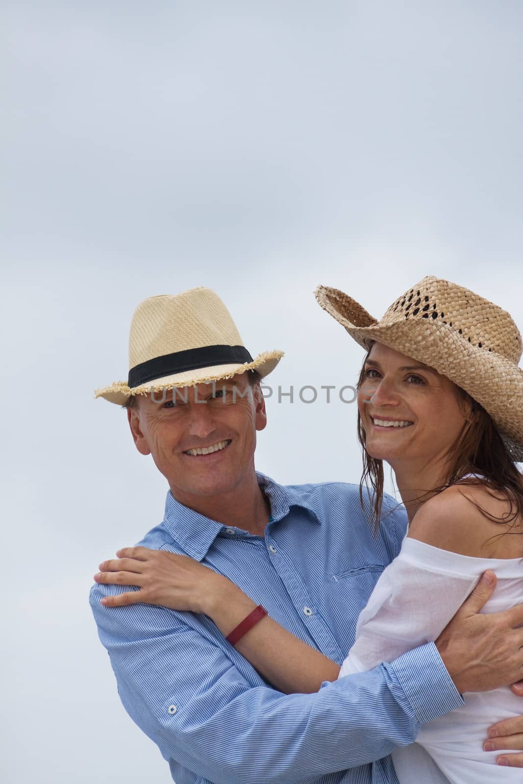 happy adult couple in summertime on beach having fun vacation