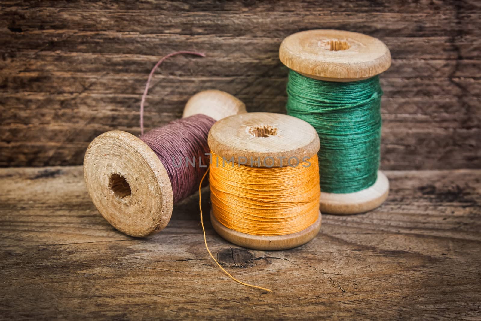 Spools of thread on a background of the old wooden planks