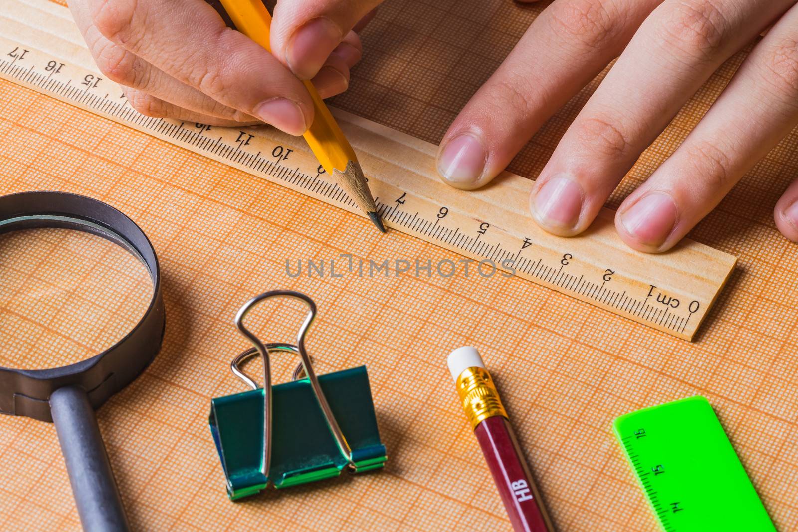 draftsman draws on a ruler on the graph paper