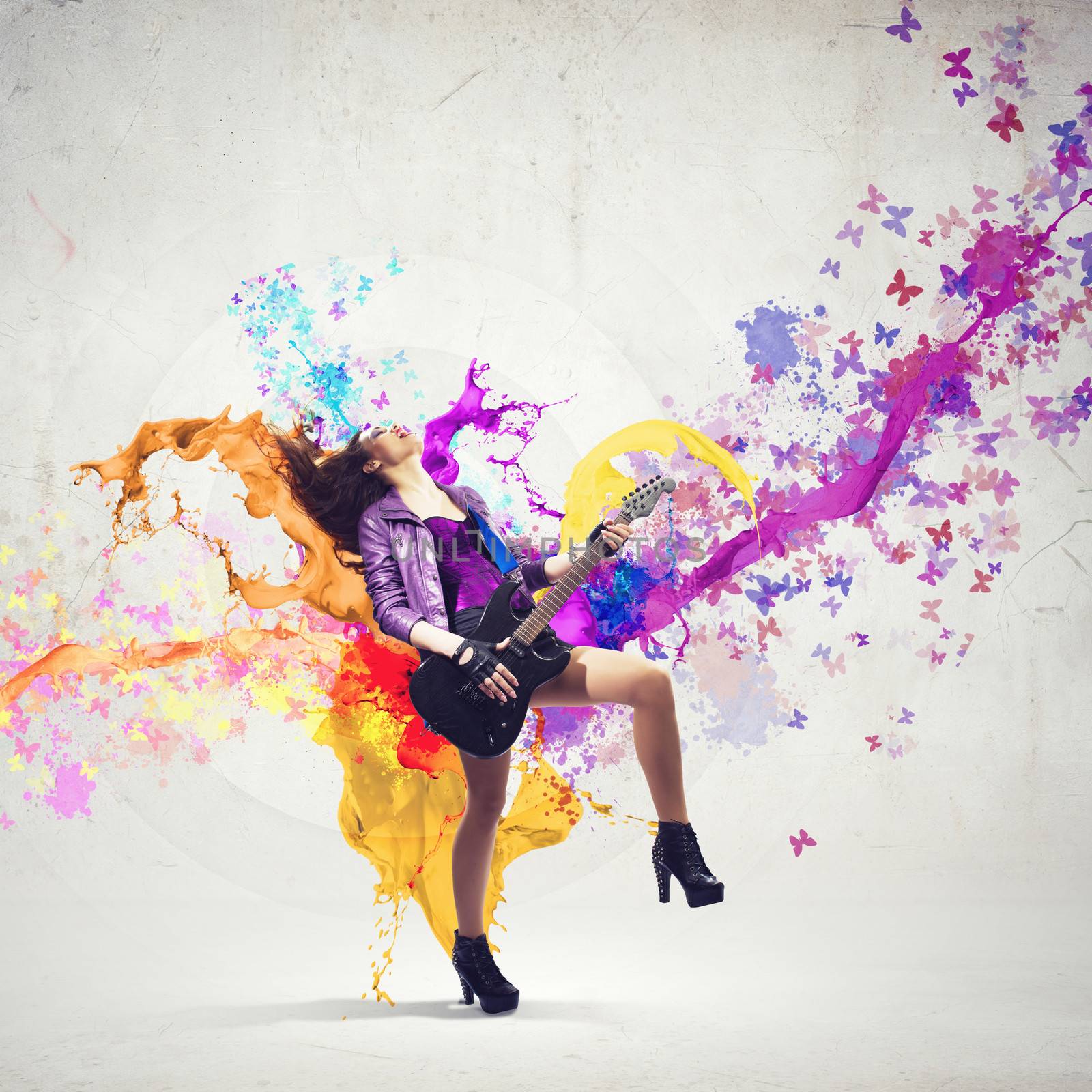 Young attractive rock girl playing the electric guitar