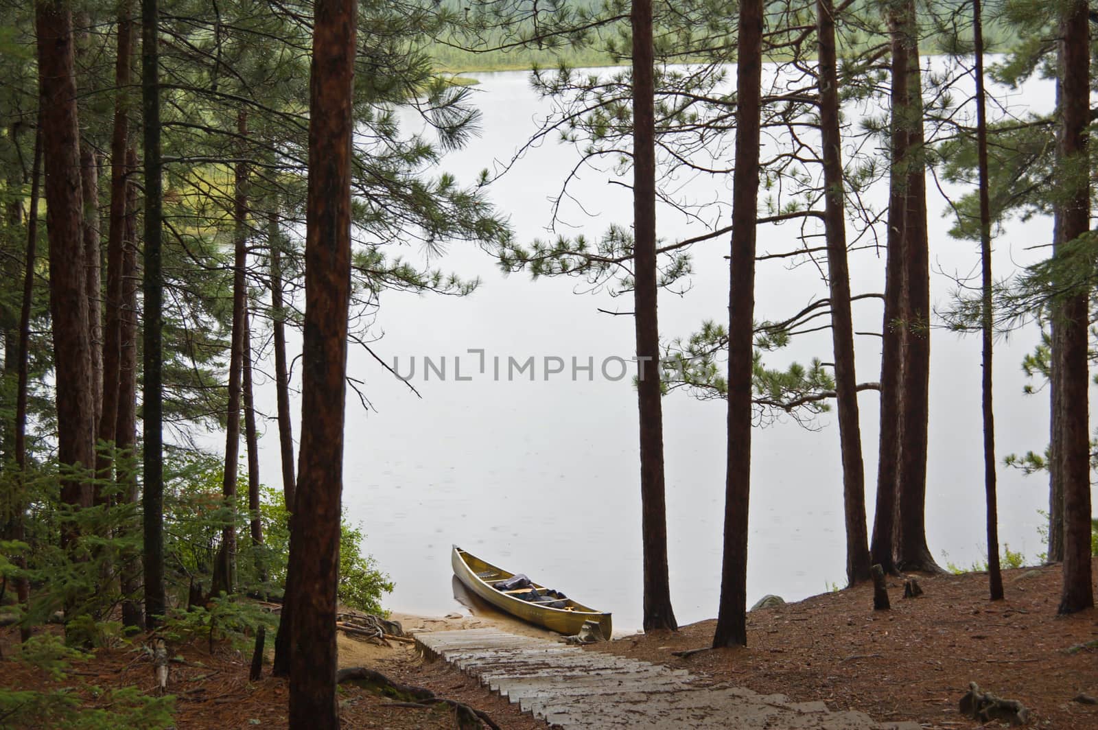 Lake and canoe before portage in rainy day in Algonquin Park