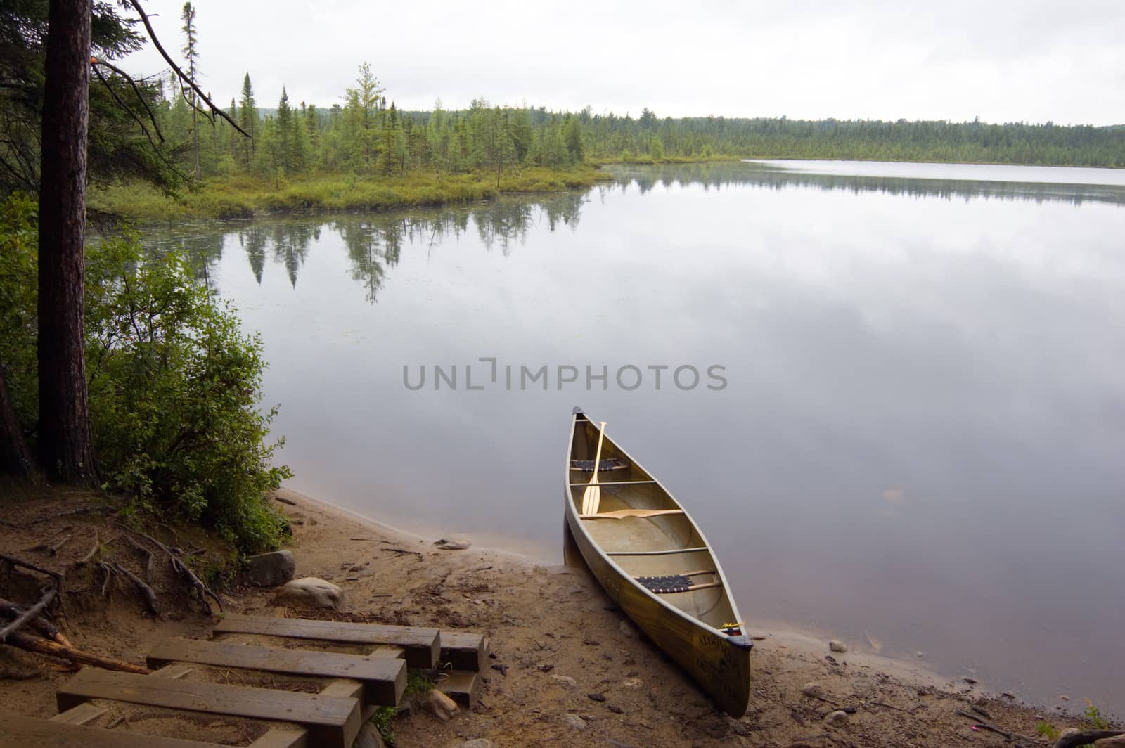 Lake and canoe before portage in rainy day in Algonquin Park