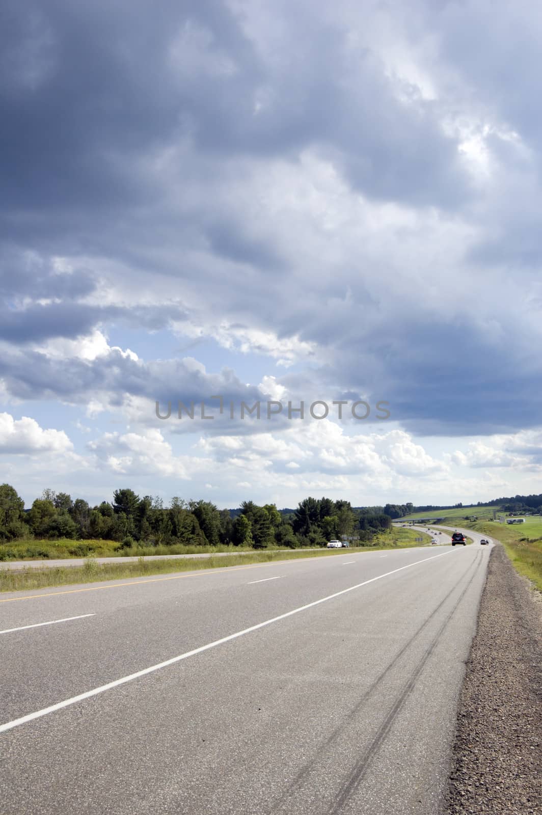 Highway through Muskoka country under cloudy sky