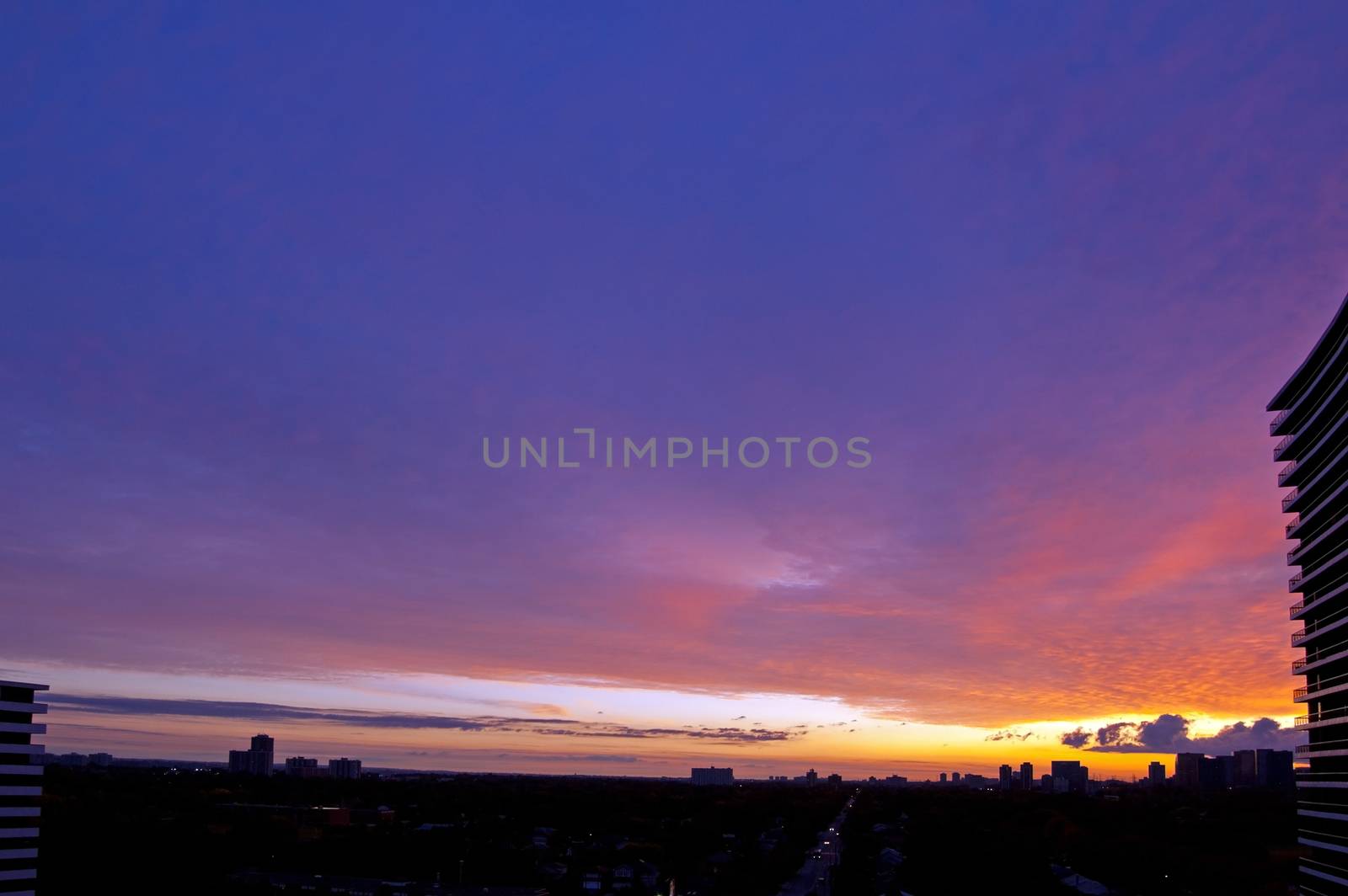 Red sunrise above street and residential area of Toronto