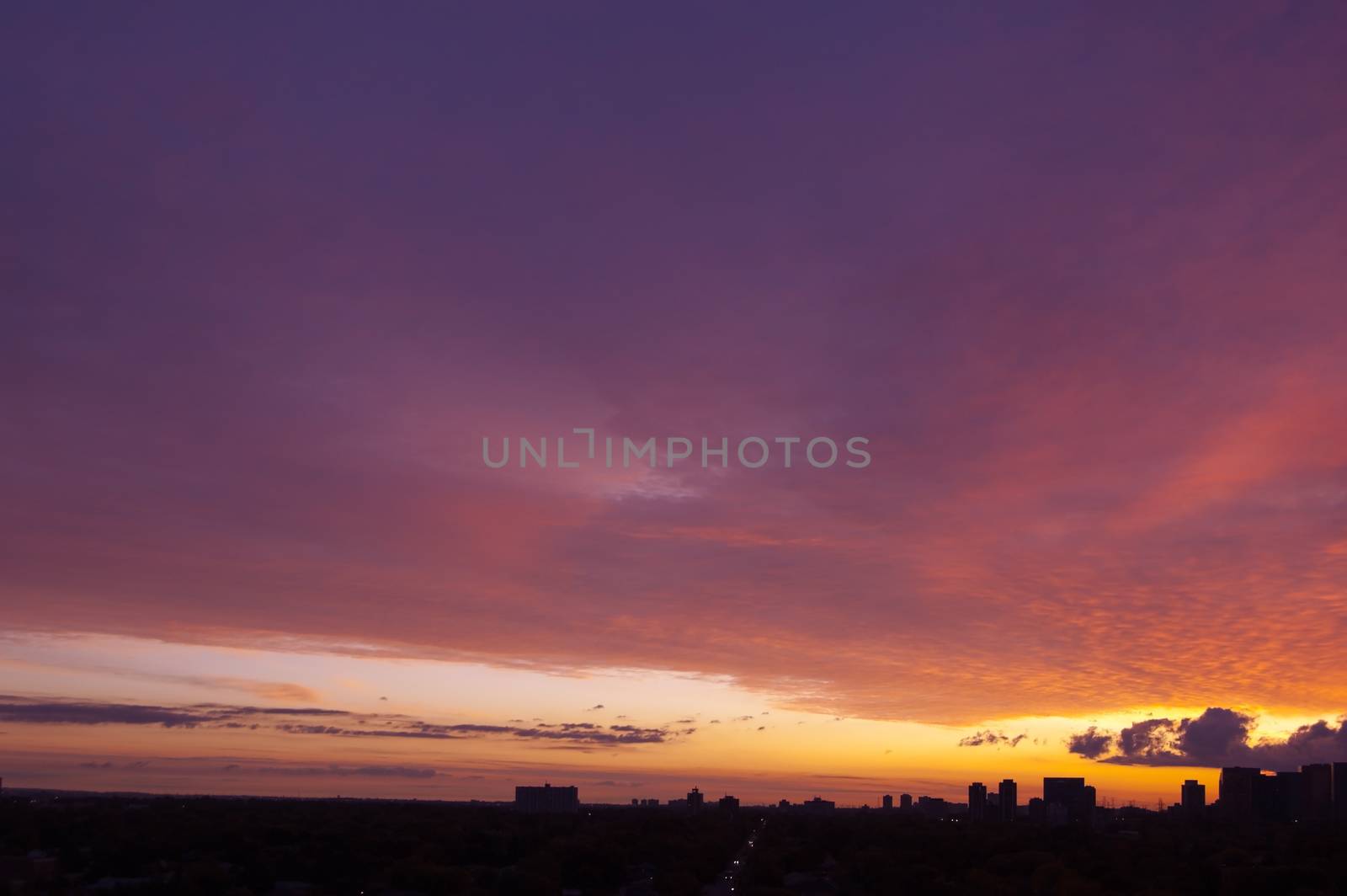 Red sunrise above street and residential area of Toronto