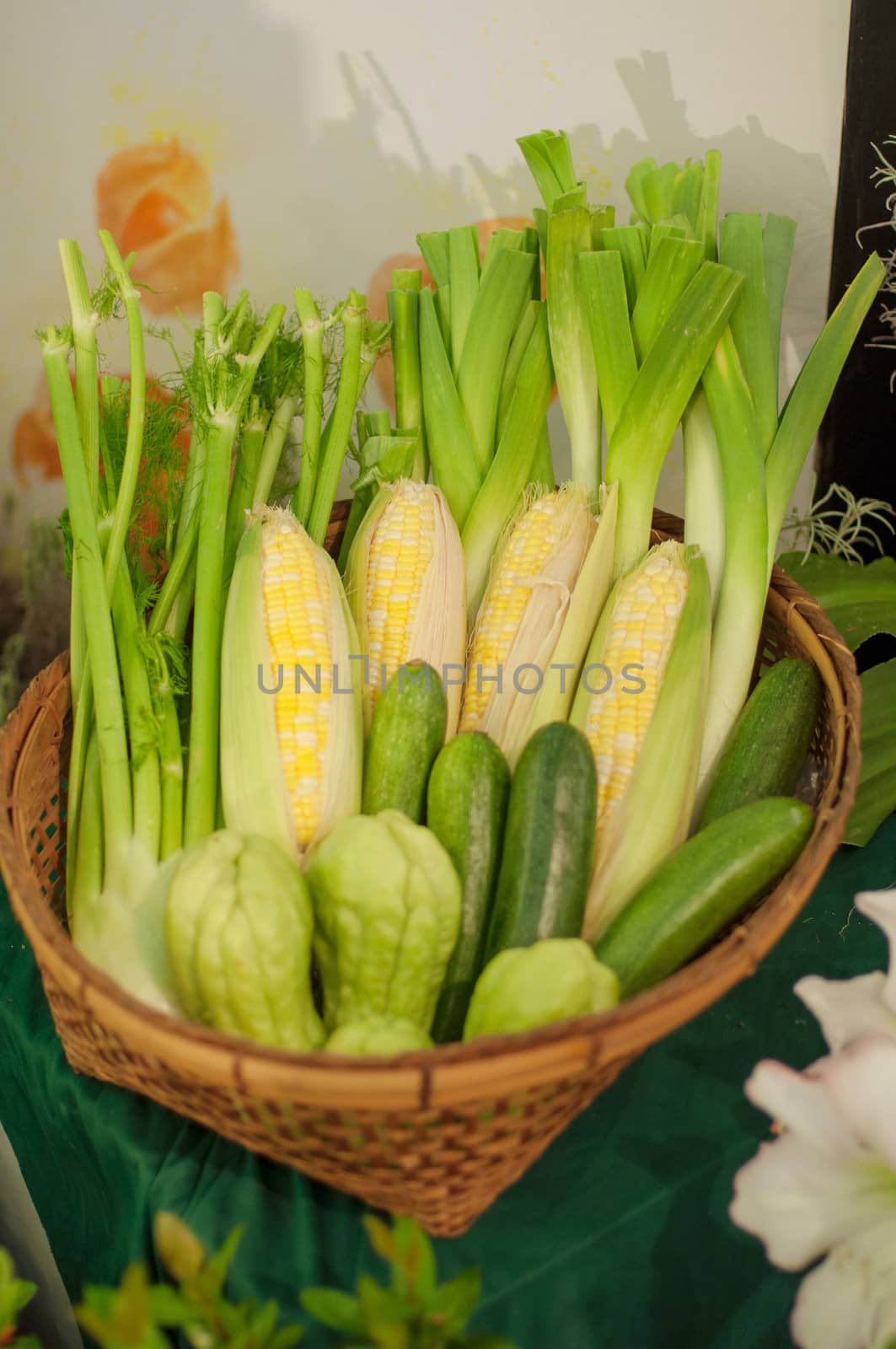 a basket of vegetables, sweet corn, bitter gorud and scallion