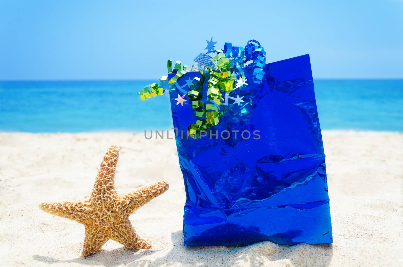 Starfish with gift bag on the beach - holiday concept by EllenSmile