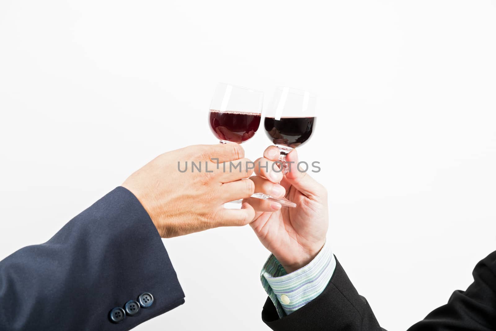 Close-up of human hands cheering up with flutes of wine