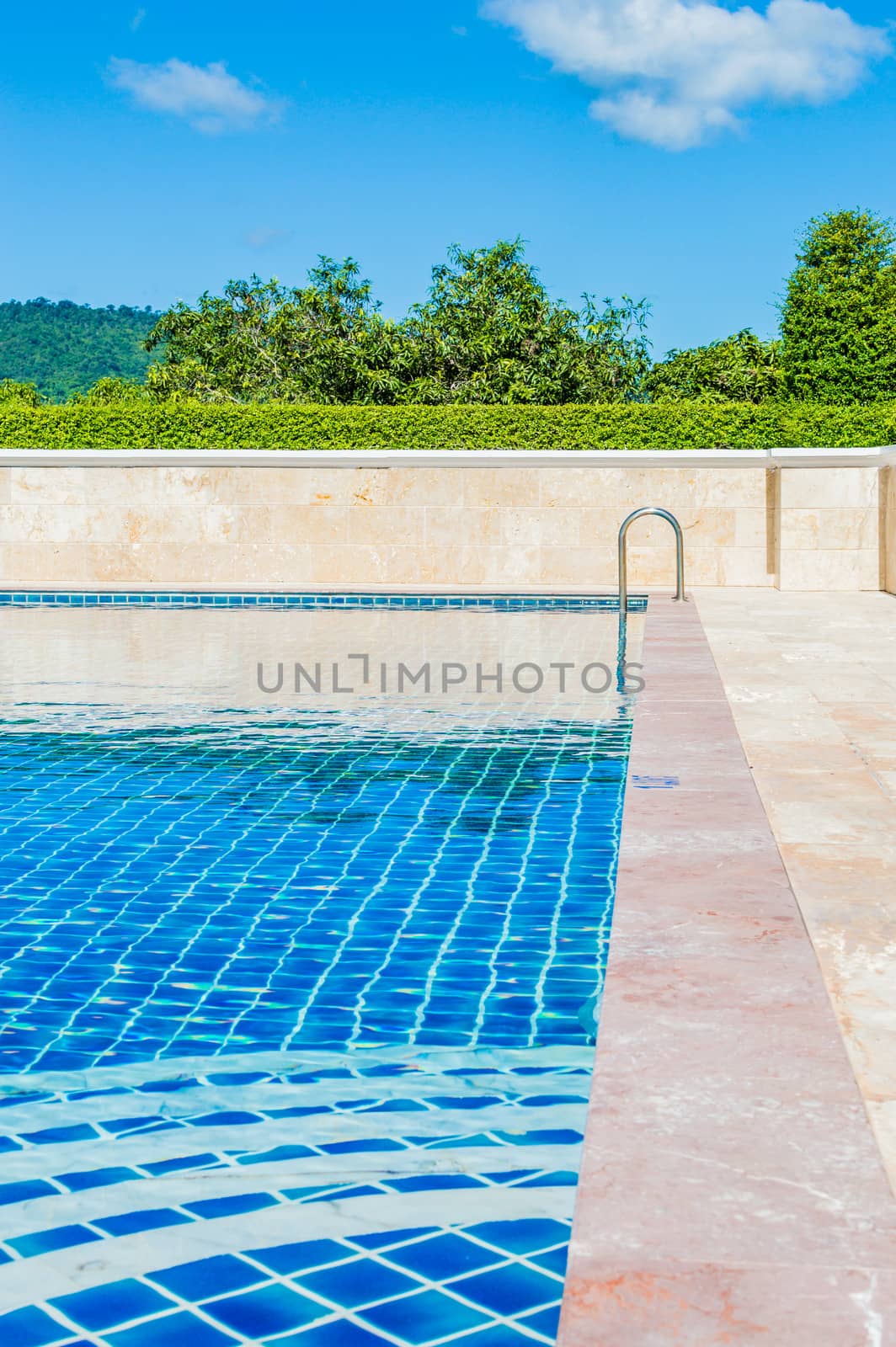 Pool blue color amid natural forest in Thailand.