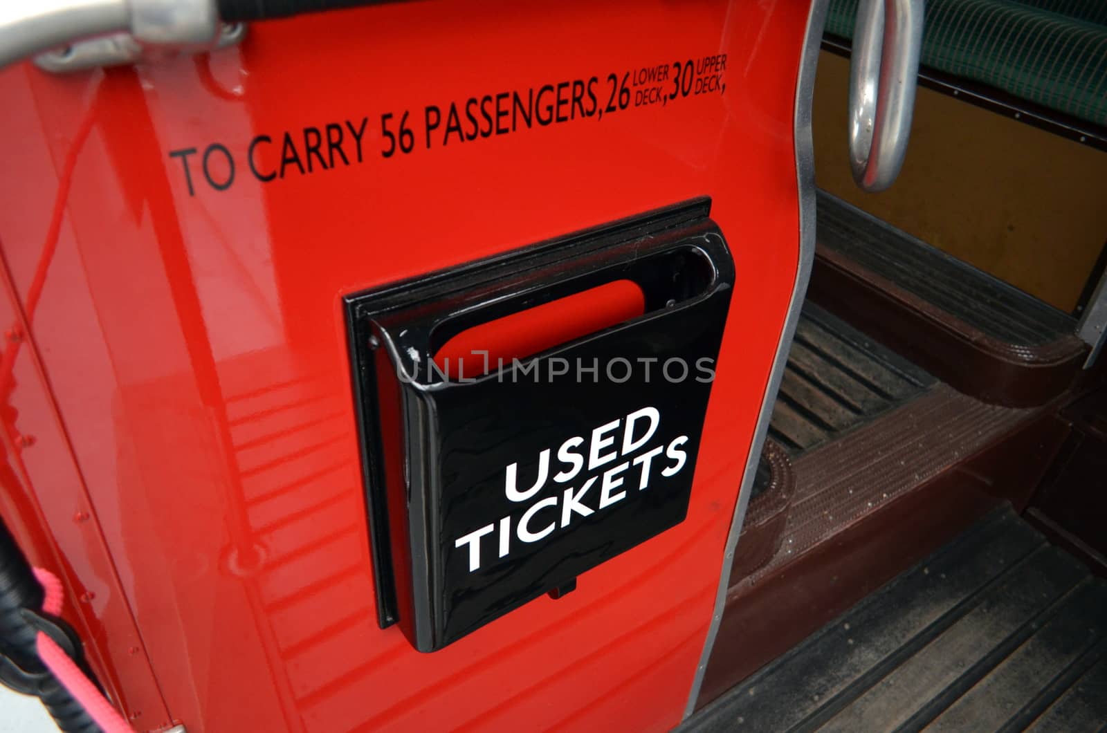 Used ticket bin on the rear entrance of a London 1950 red Routemaster bus.