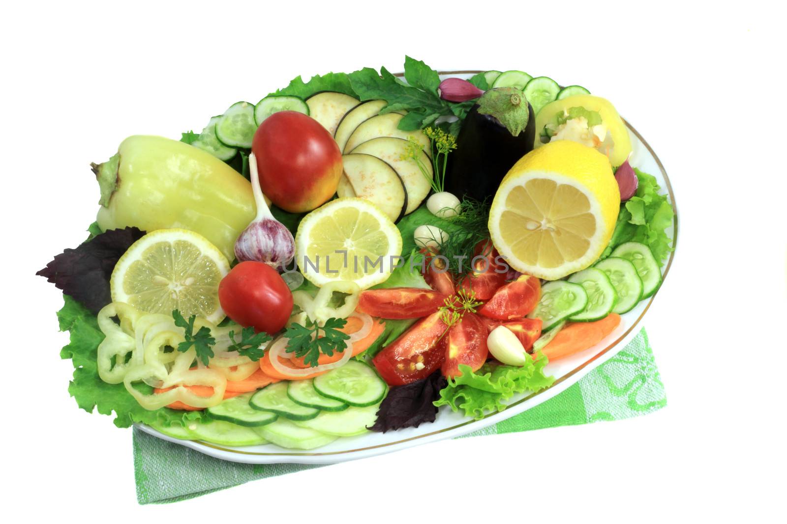 A variety of chopped vegetables and fruits, located on a ceramic dish. Presented on a white background.