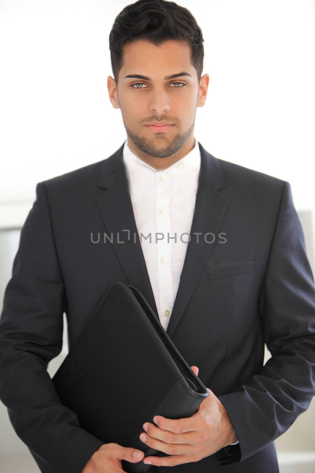 Serious young businessman with a folder by Farina6000