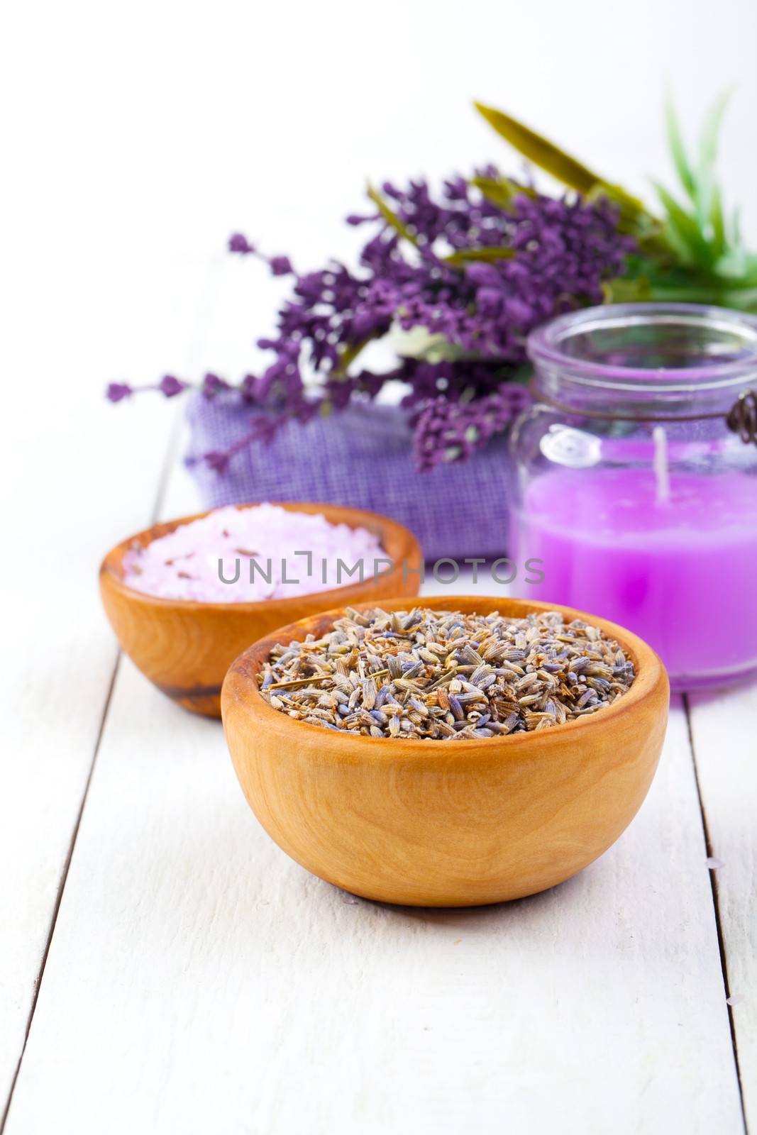 dry Lavender herbs, bath salt and candle, on white wooden table by motorolka