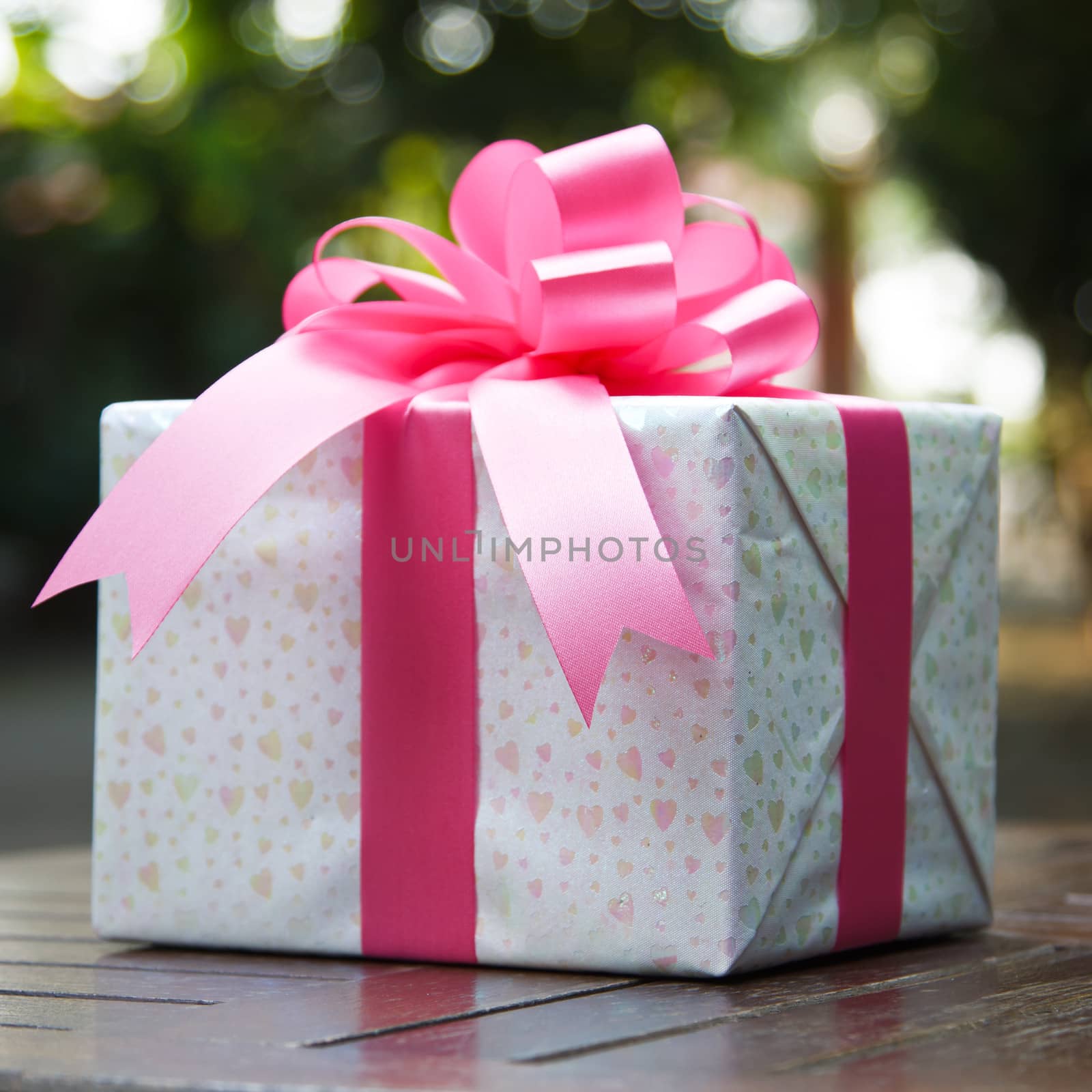 Images of pink gift boxes located on the table