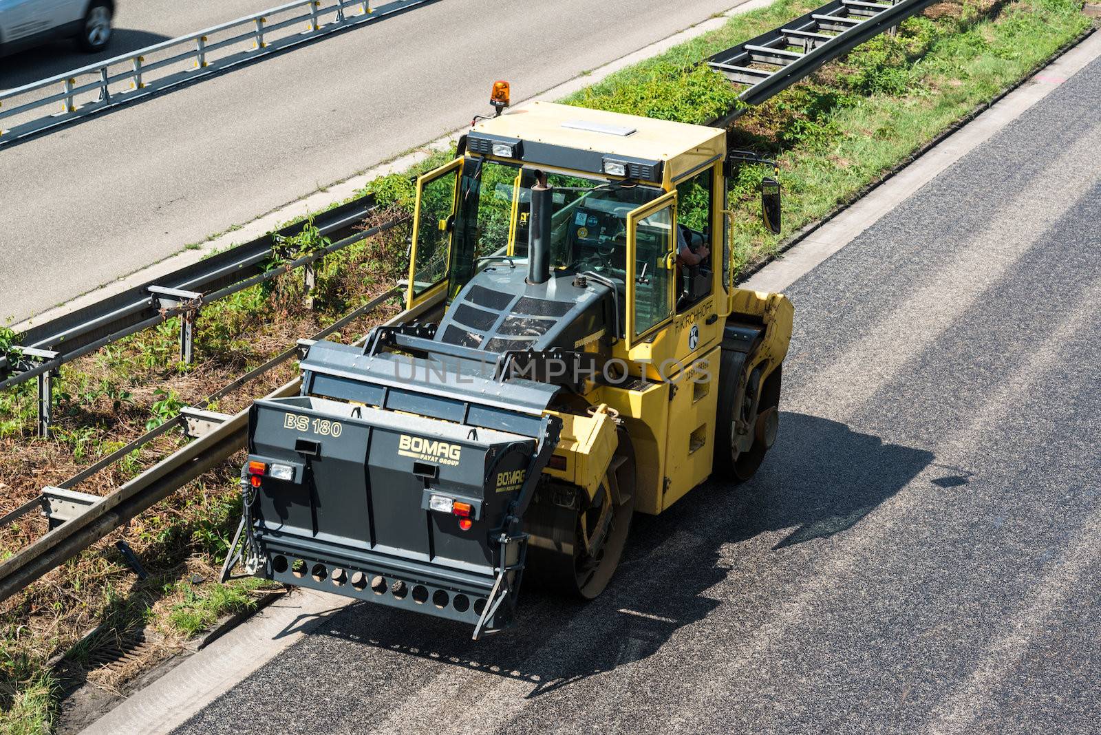 STUTTGART, GERMANY - AUGUST 10,2013: Workers laying asphalt on a public interstate (B27) during holiday season on August 10, 2013 in Stuttgart, Germany.