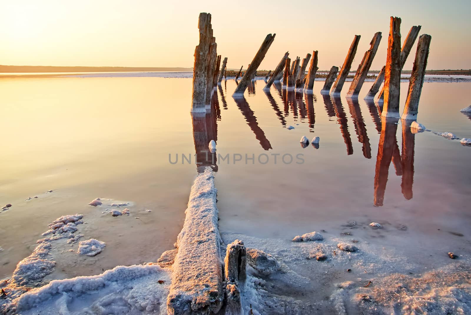 Sunset over the salt lake. All objects in this lake covered with salt. by Zhukow