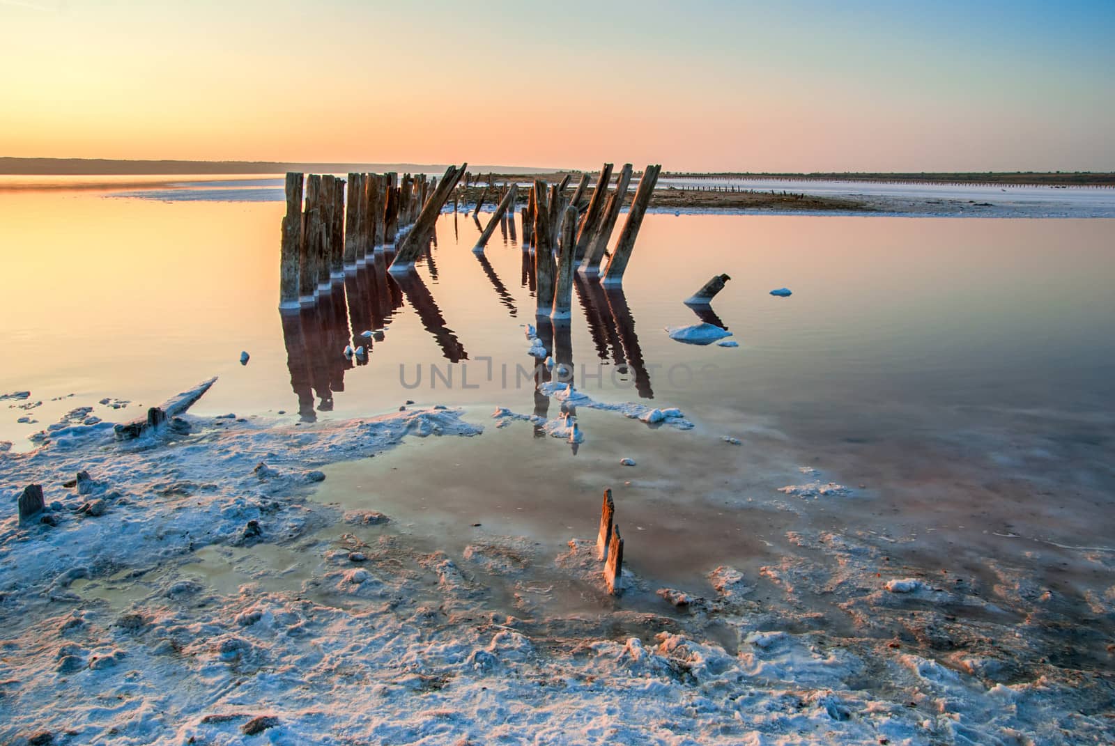 Sunset over the salt lake. All objects in this lake covered with salt. by Zhukow