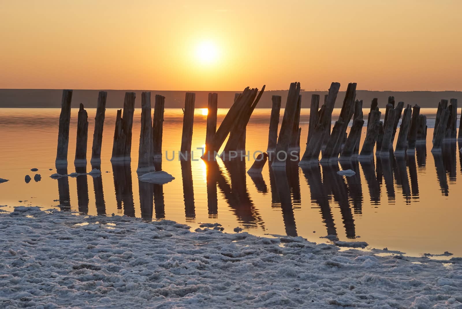 Sunset over the salt lake. All objects in this lake covered with salt. by Zhukow