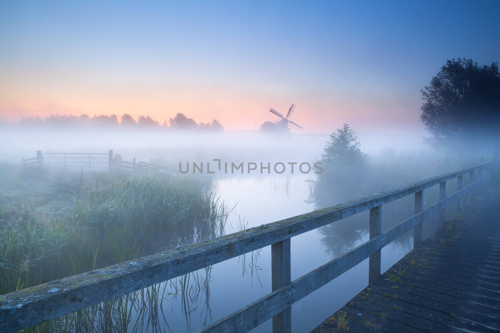 view on windmill ib fog from bridge over river, Holland