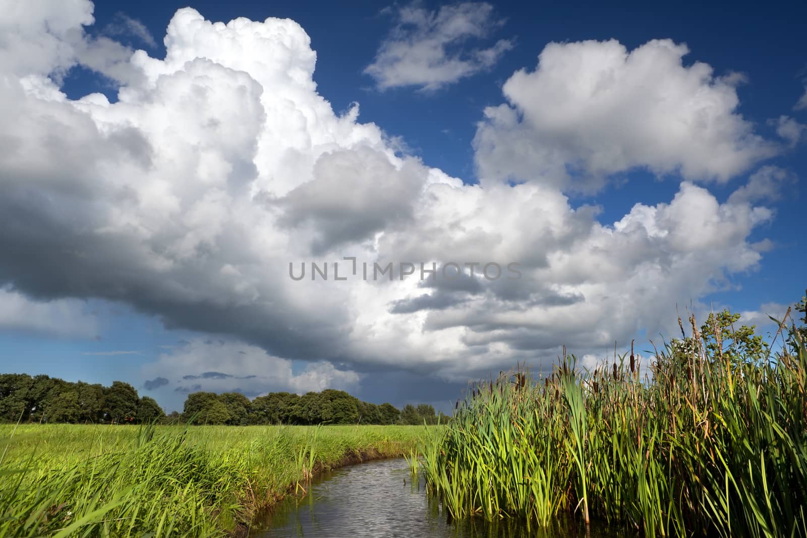 dramatic storm clouds on blue sky over river