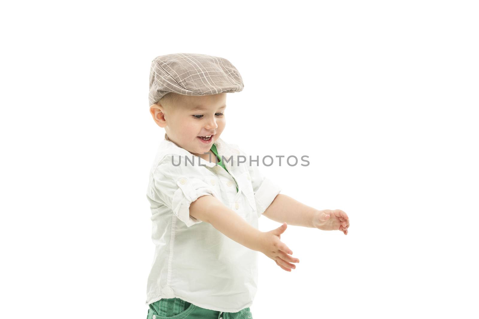 Laughing youngster wearing a cute cloth cap holding out his hands as though reaching for something, upper body portrait isolated on white