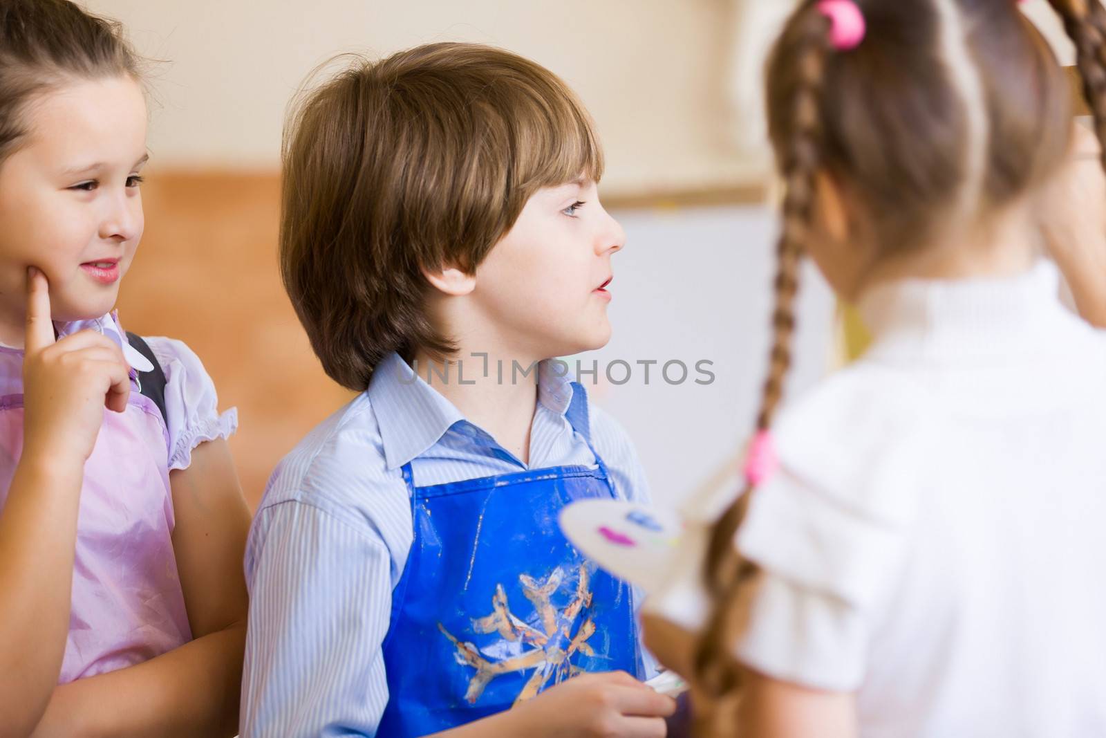 Little children painting and playing at kindergarten