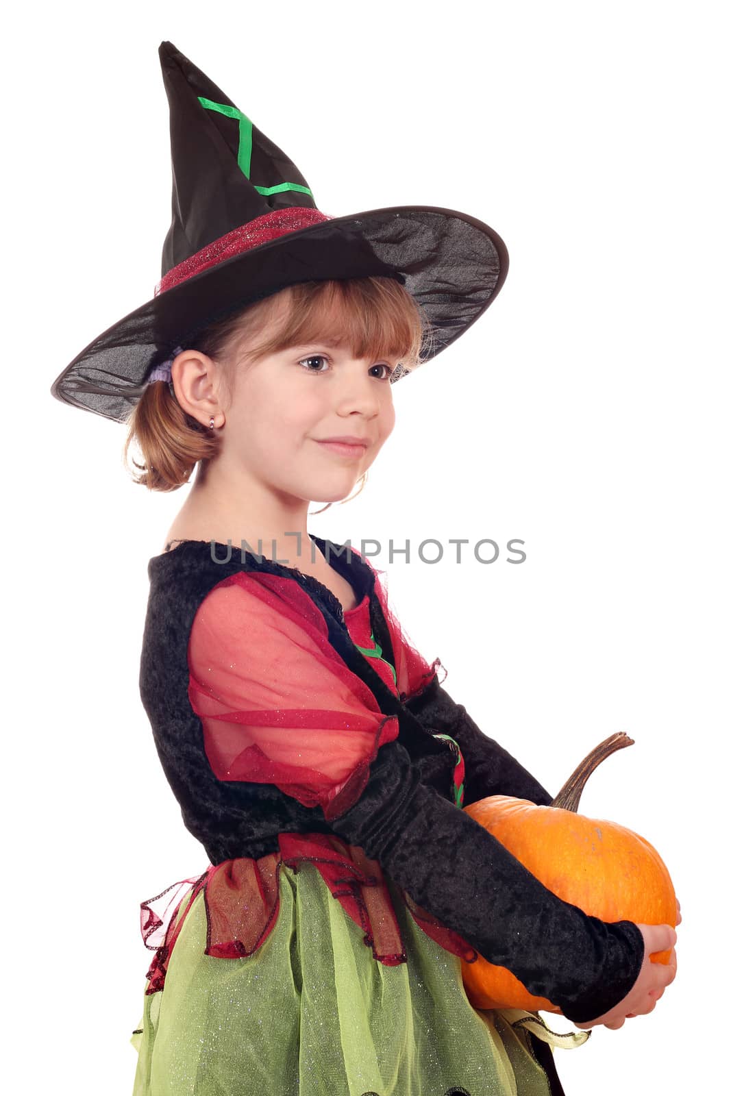 little girl witch holding pumpkin on white 